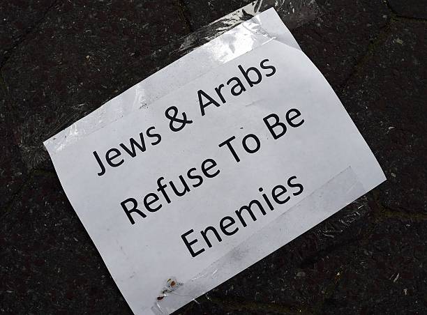 A poster left by a participant taking part in a candlelight vigil and silent protest organized as part of the #JewsAndArabsRefuseToBeEnemies August 11, 2014 near the United Nations in New York. AFP PHOTO/Don Emmert (Photo credit should read DON EMMERT/AFP via Getty Images)